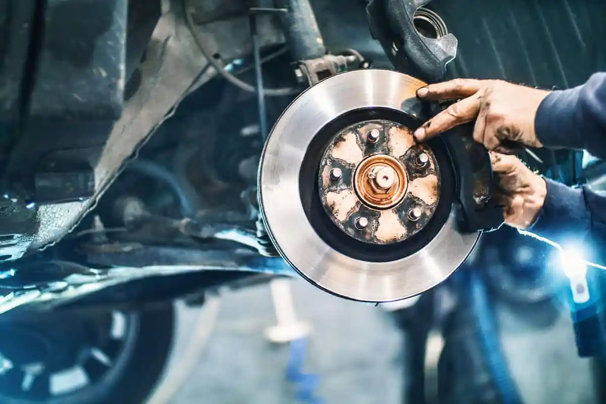 Mechanic fitting a new brake rotor during a brake service